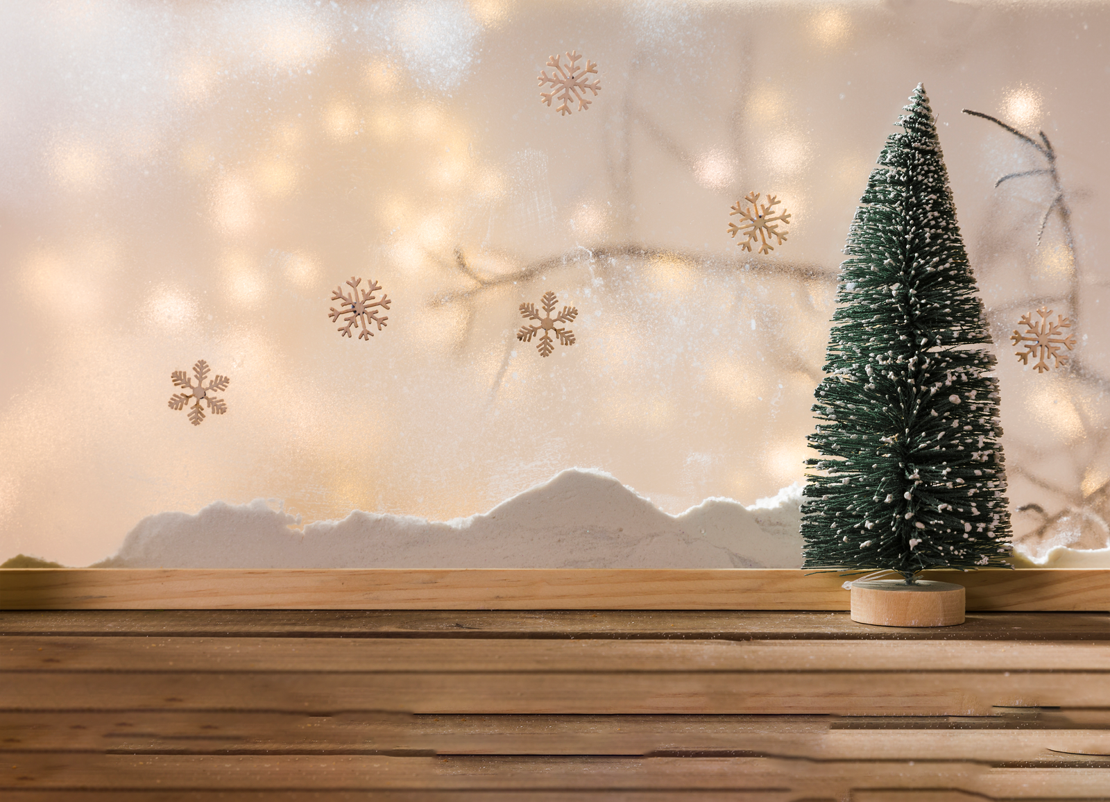 toy-fir-tree-wood-table-near-bank-snow-plant-twig-snowflakes-fairy-lights